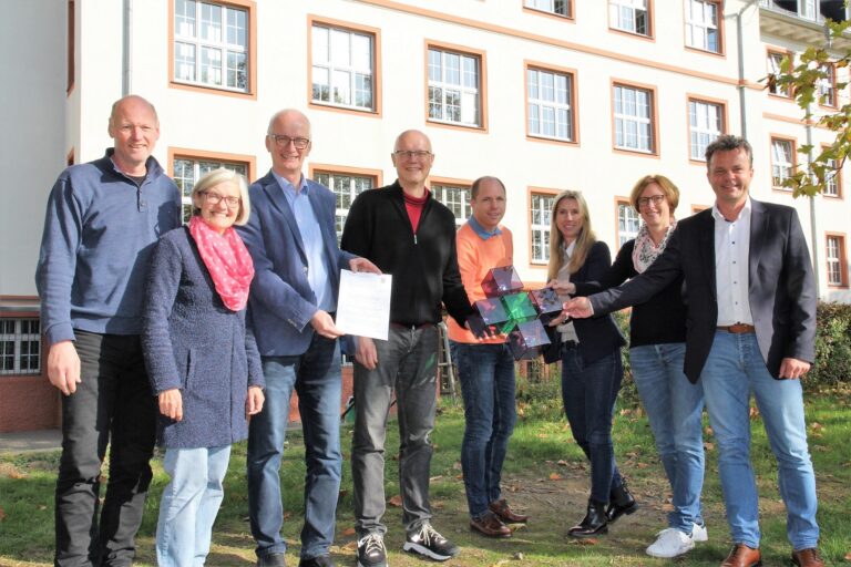 Eine Gruppe von Menschen steht vor einem Gebäude.