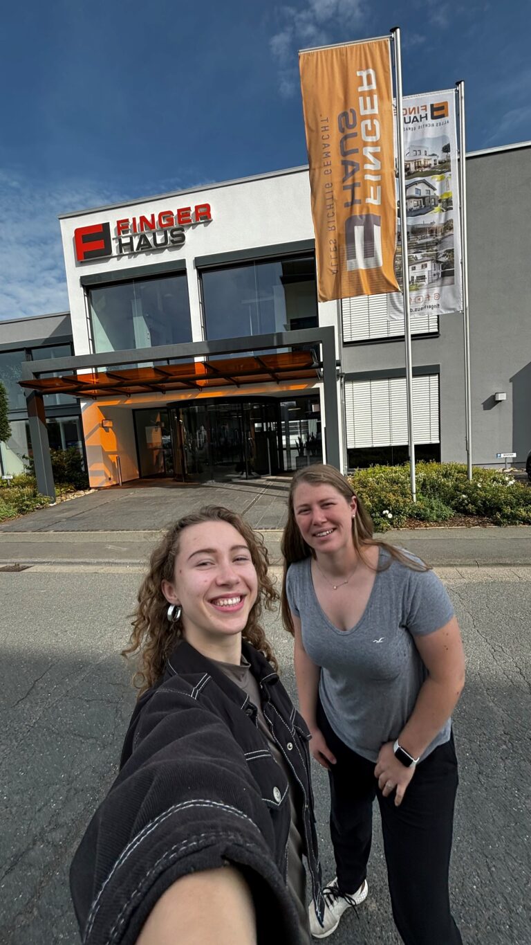 Zwei Studentinnen stehen vor dem Firmengebäude von Fingerhaus.